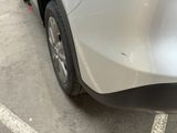 a white car parked in a parking lot next to a building