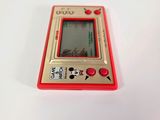 a small red gameboy sitting on a white surface