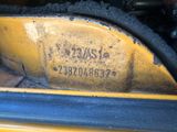 a close up of a yellow car with a number on it