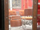 a mirror that is sitting on a table in front of a chair