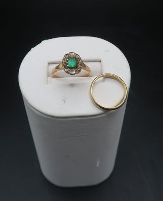 a white box with a ring and a green ring on it