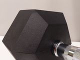 a black hexagonal object on a white surface
