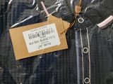 a picture of a black shirt with a tag on it