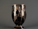 a vase with a black and gold design on it