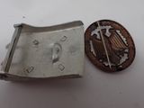 a metal belt buckle and a coin on a table