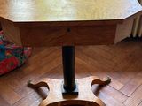 a wooden table with a metal base on a wooden floor
