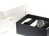 a box with a watch inside of it on a white surface
