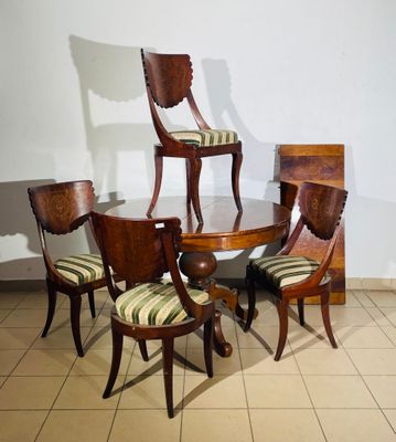 several chairs and a table in a room with a white wall
