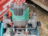 a green and black electric drill in a blue box