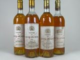 three bottles of wine sitting on top of a white table