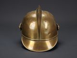 brass helmet on a black background with a gray background