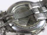 a close up of a watch on a white surface