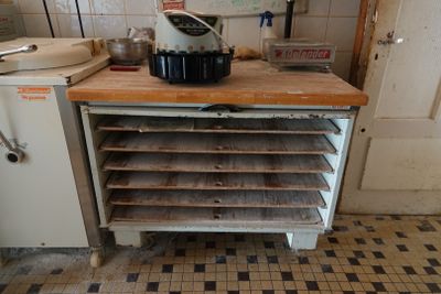 a kitchen with a stove, oven, sink, and cabinets