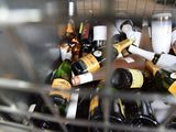 many bottles of wine in a metal basket on the table