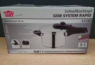packaging of a stainless steel pressure cooker on a wooden table