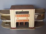 a small toy car with a garage on top of it