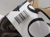 someone is holding a pair of shoes with a bar code on them