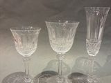 three wine glasses sitting on top of a table next to each other