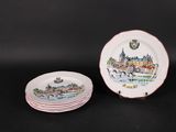three plates with a picture of a city on them