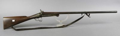 an old rifle with a wooden barrel on a stand