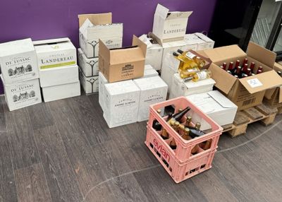 several boxes of wine are stacked next to each other on the floor