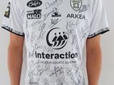 Cet homme porte une chemise blanche avec des inscriptions noires dessus.