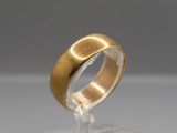 an image of a close up of a gold ring on a clear surface
