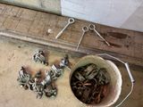 a bucket of screws and a pair of scissors on the floor
