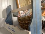 a picture of a shelf with a basket and a pair of scissors