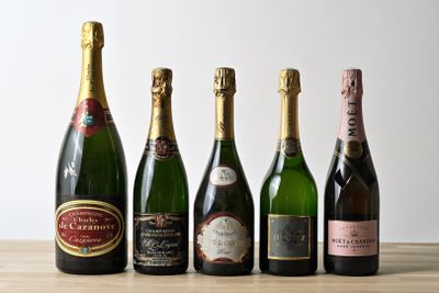 six bottles of champagne are lined up on a wooden table