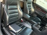 the interior of a car with black leather seats and a red trim