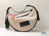 a purse with a tag on it sitting on a table