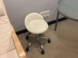 a white chair and a table in a small room