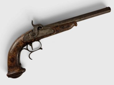 a close up of a gun on a wall with a white background