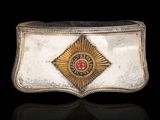 a close up of a belt buckle with a red stone in the center