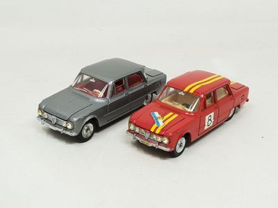 two toy cars sitting next to each other on a white surface