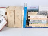 several books are stacked on top of each other on a table