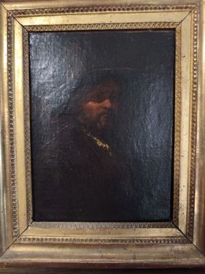 une peinture à l'huile représentant un homme barbu, dans un cadre doré