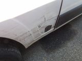 a white truck with a hole in the side of it ' s door
