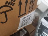 a cardboard box with a sticker on it sitting on top of a pile of boxes