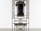 a metal shelf with a mirror on top of it in a room