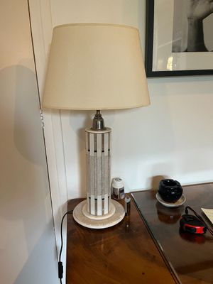 a lamp that is sitting on a table next to a picture