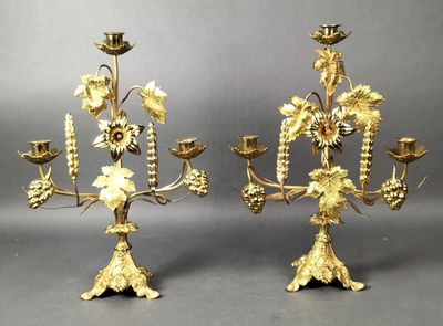 pair of gold plated candelabs with flowers and leaves
