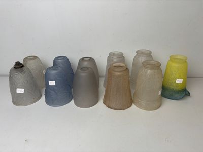 several different colored vases are lined up on a white surface