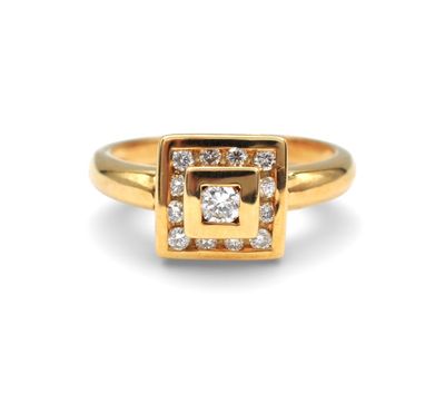 a close up of a gold ring with a diamond in the center