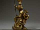 bronze statue of a boy with a fish and a basket on his head
