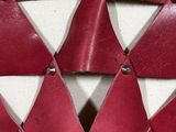 a close up of a red and white wall with triangles