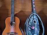 three guitars that are sitting on a wooden table