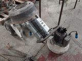 une machine posée par terre à côté d'un tas de bois