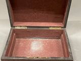 a small wooden box that is open on a white surface